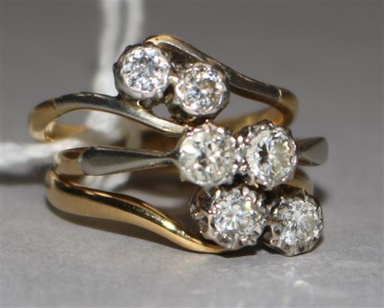 Two 1930s 18ct gold and two stone diamond rings and one yellow metal and two stone diamond ring.